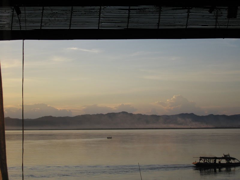 smoke rising at dusk on the opposite shore of the Irrawaddy
