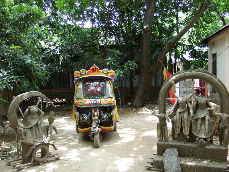 people of the village were already preparing for Durga Puja (biggest hindu festival in Bangladesh) which was 3 months away. these clay sculptures (on either side of baby taxi) were baking in the sun.  later, they'd be painted for the puja
