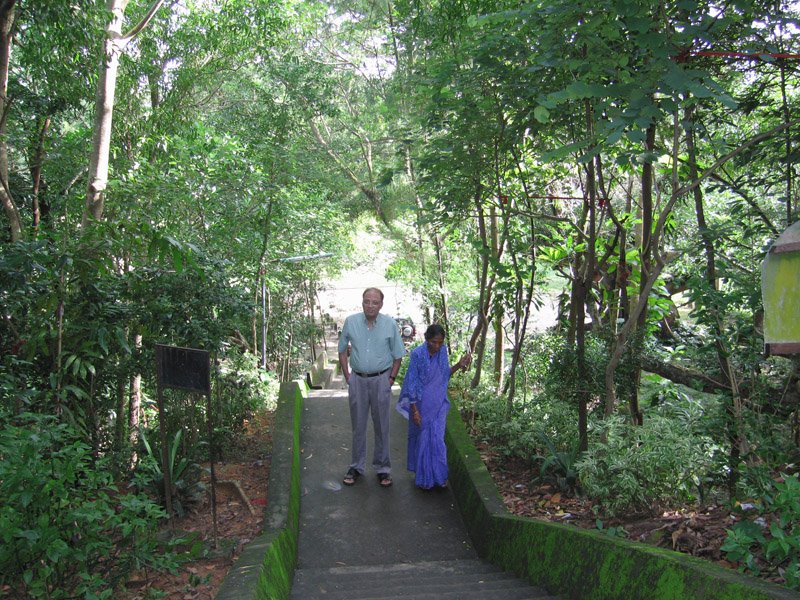 Abbu and old woman on steps to temple
