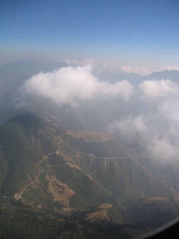 flying low over the countryside, you can see the roads and villages built into the mountains
