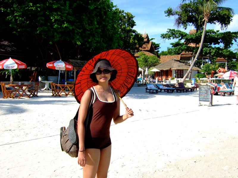 walking the beach on koh samui, anika with the monk's parasol she got in yangon

