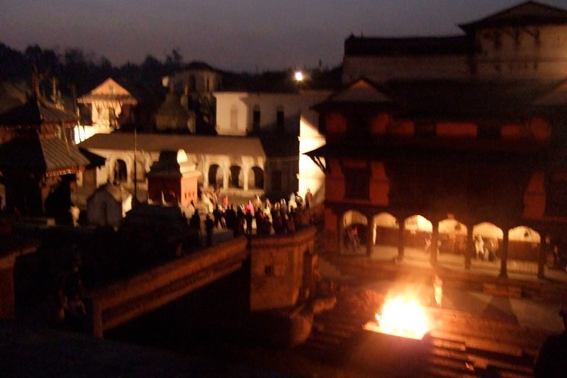 looking down onto the cremation from the other side of the ghat, surrounded by death, life, music and dancing all at the same time
