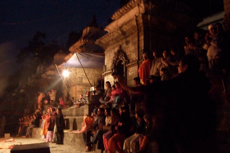 crowds of people were gathered here in the dark to watch these religious performers
